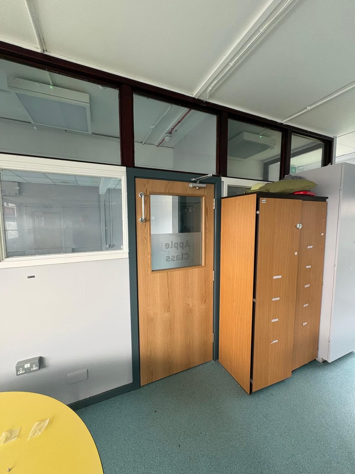 Fire door with vision panel fitted into a glazed classroom partition in a Knowsley school