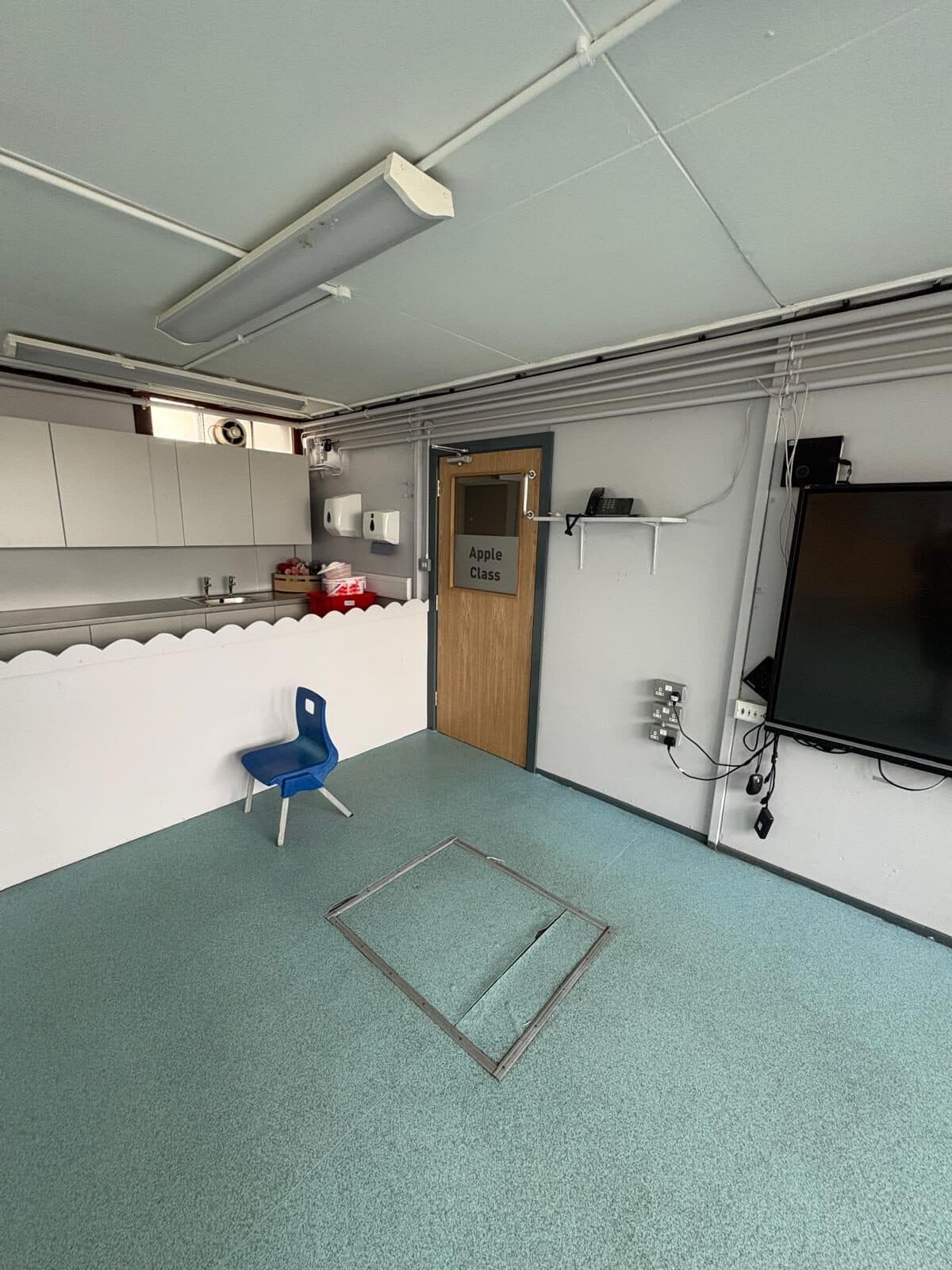 Inside a school classroom looking at a newly fitted fire door with an overhead closer