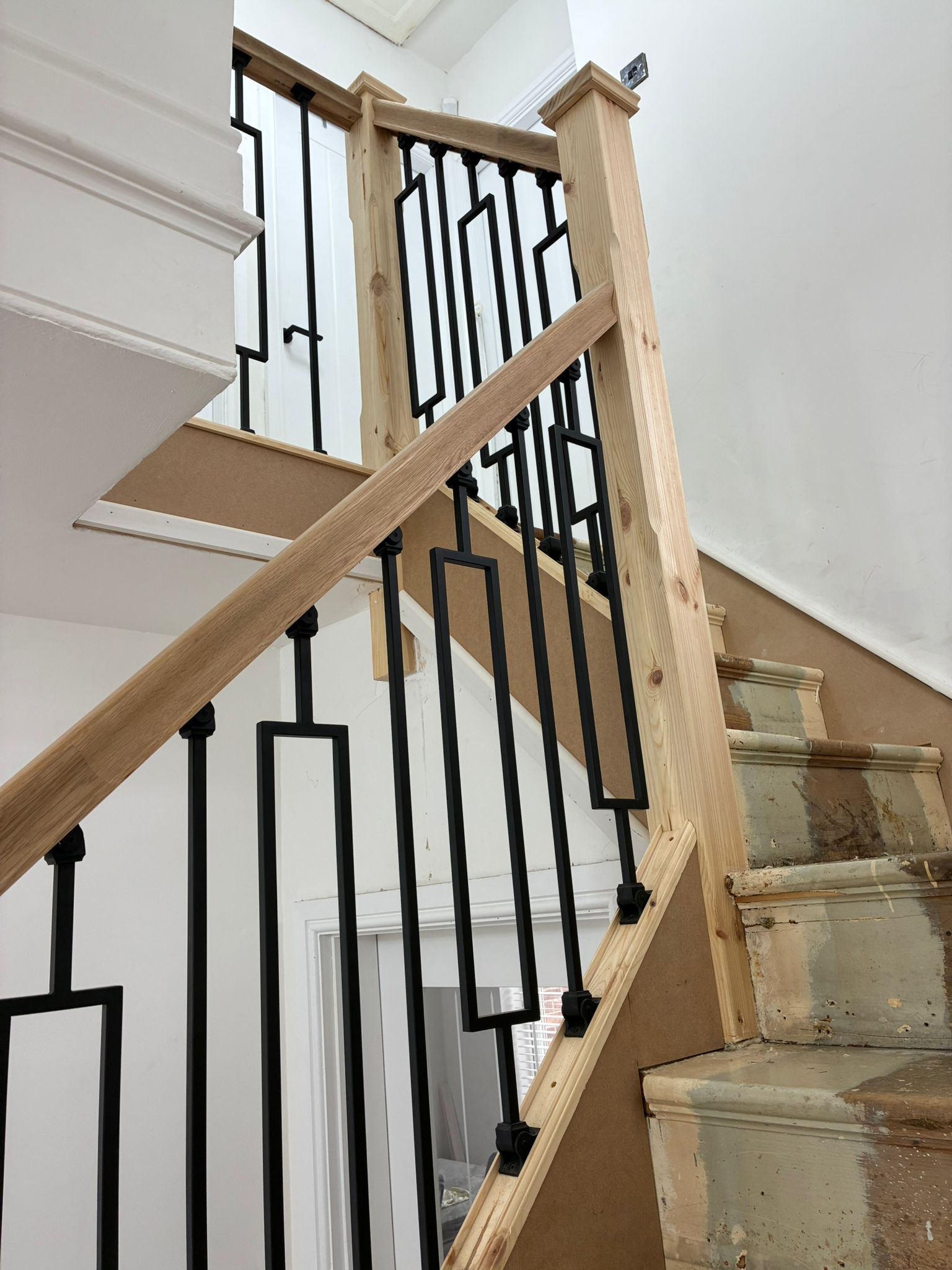 Oak staircase with black metal balustrade