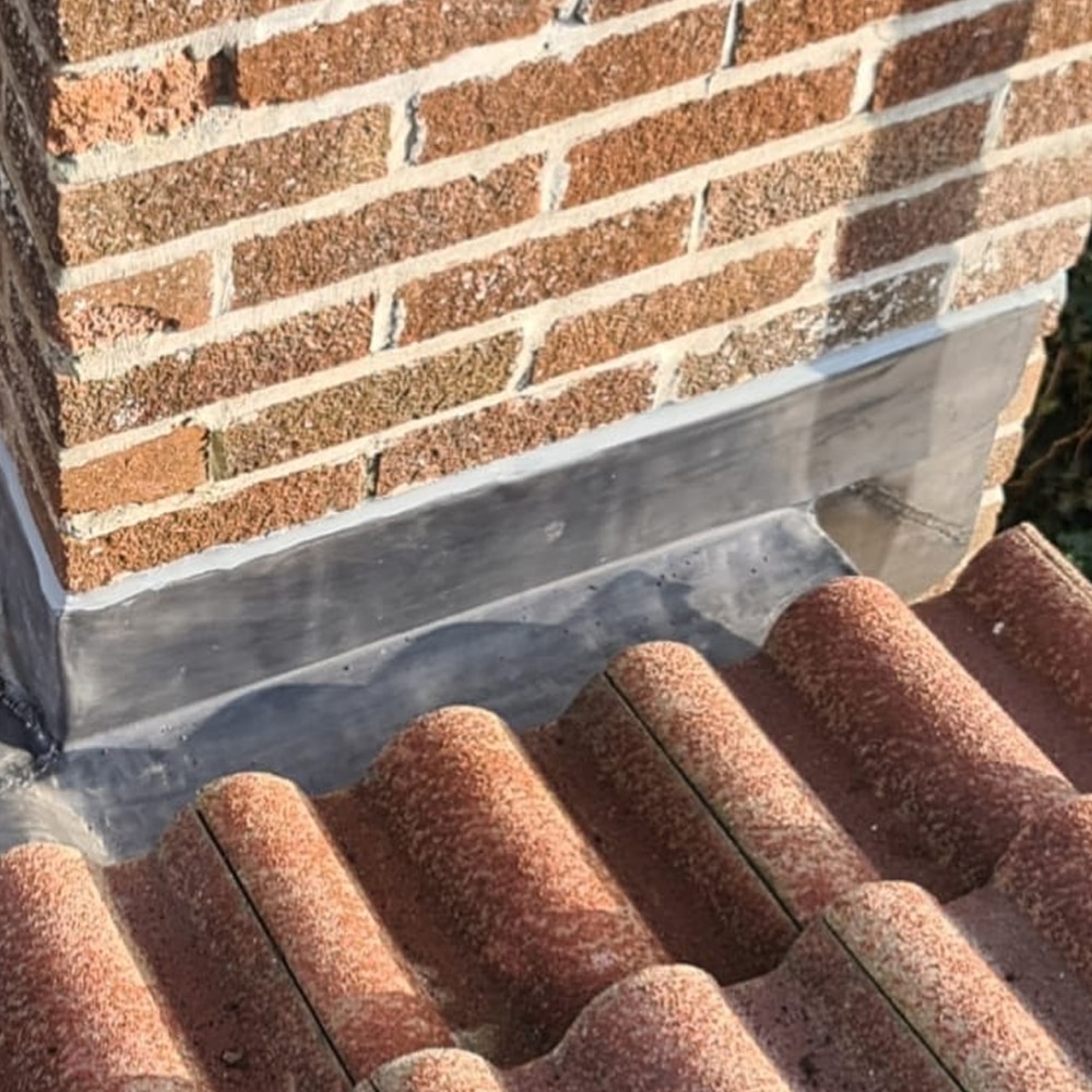 Lead flashing dressed around a chimney base